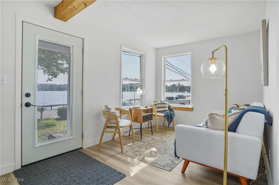 Living area with wood finished floors and a water view