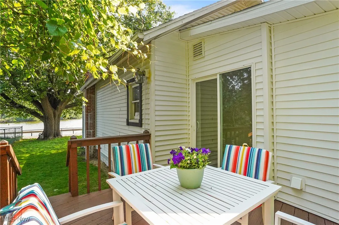 Wooden deck with a lawn and outdoor dining space