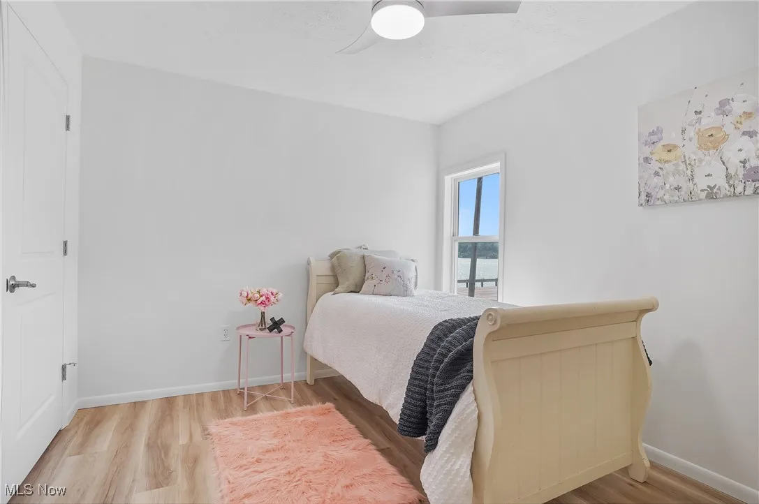 Bedroom with wood finished floors and a ceiling fan
