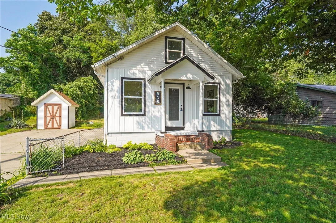 Bungalow-style house featuring a storage shed and board and batten siding