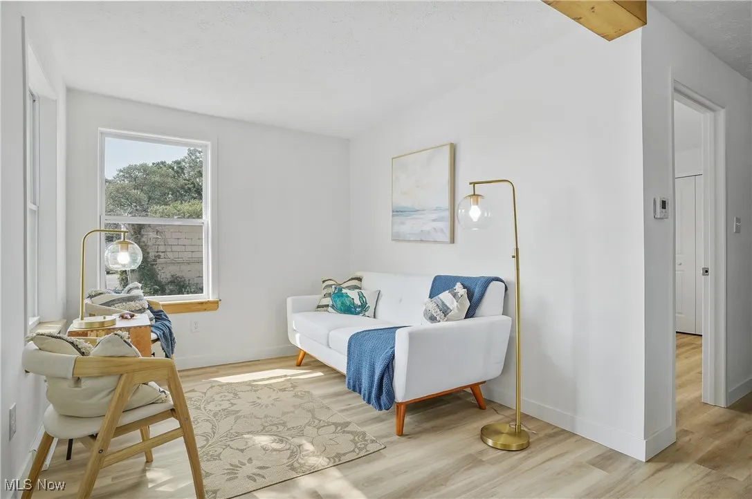 Bedroom featuring wood finished floors and baseboards