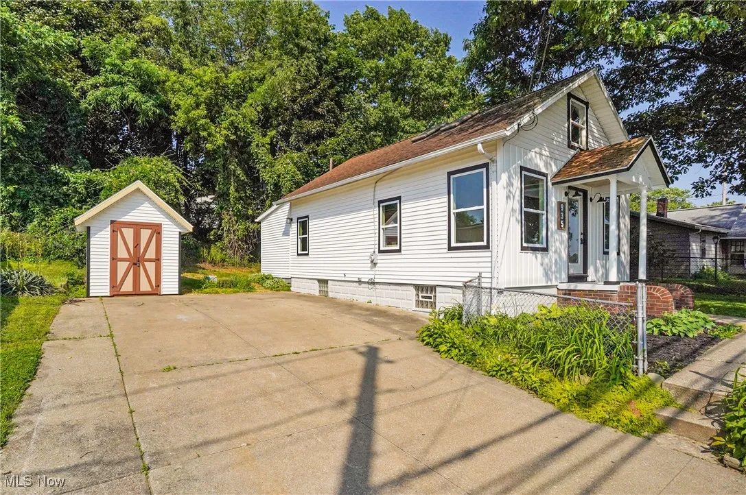 View of front of home with a shed