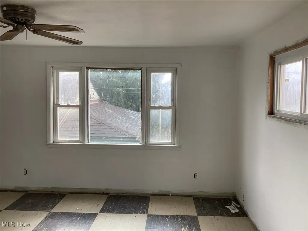 Unfurnished room featuring a ceiling fan