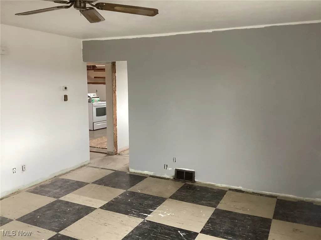 Unfurnished room featuring ceiling fan