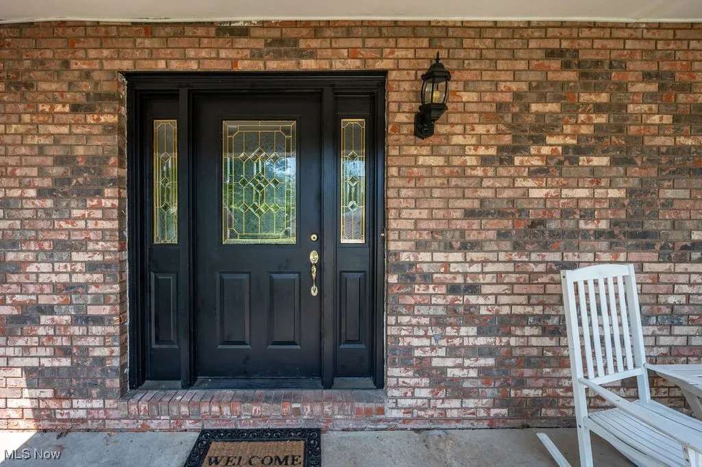 Entrance to property with brick siding