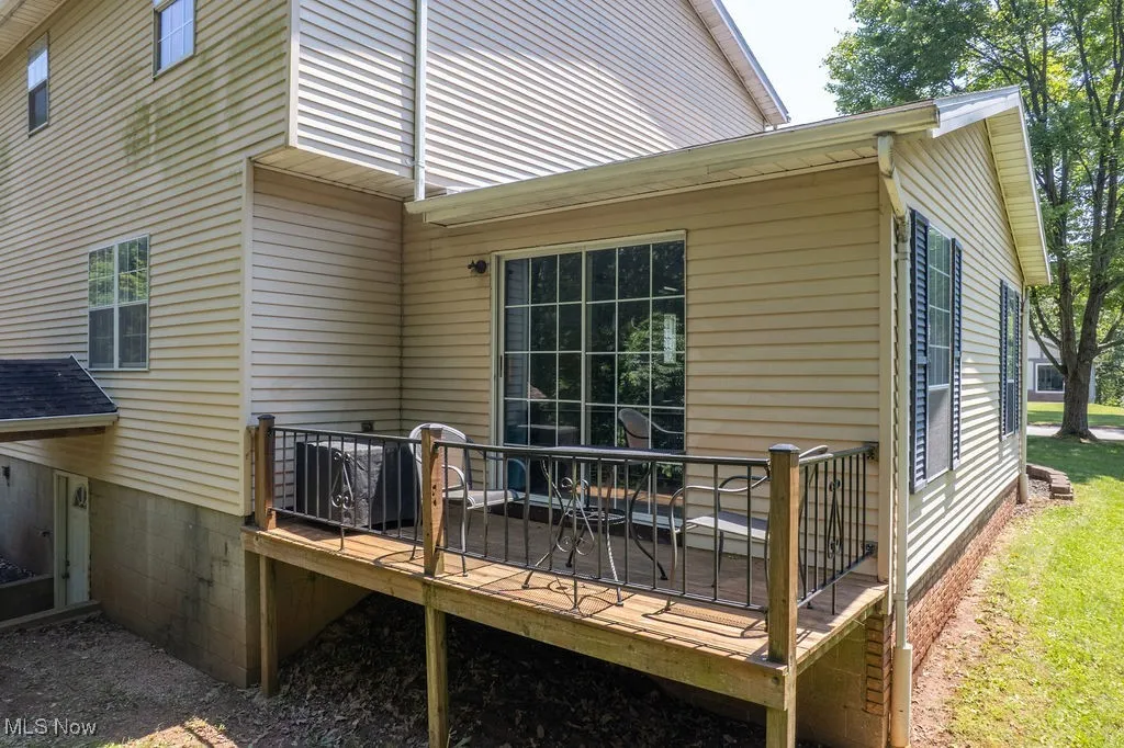 Back of property featuring a wooden deck