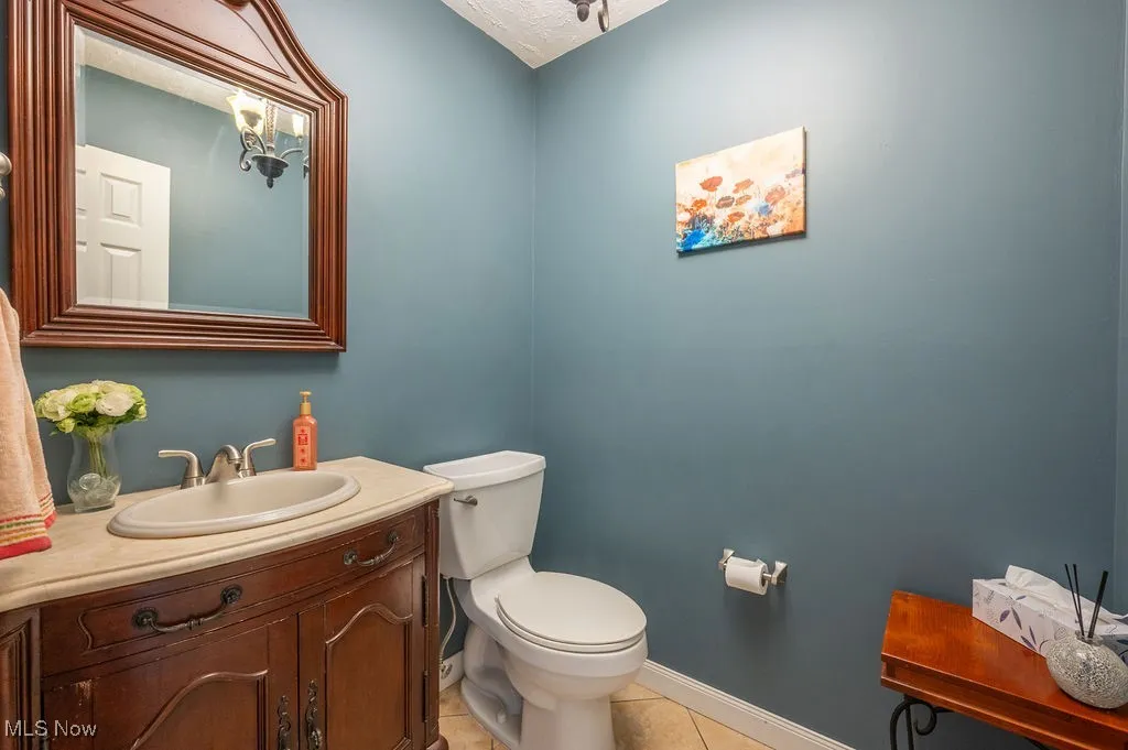 Bathroom with tile patterned floors and vanity