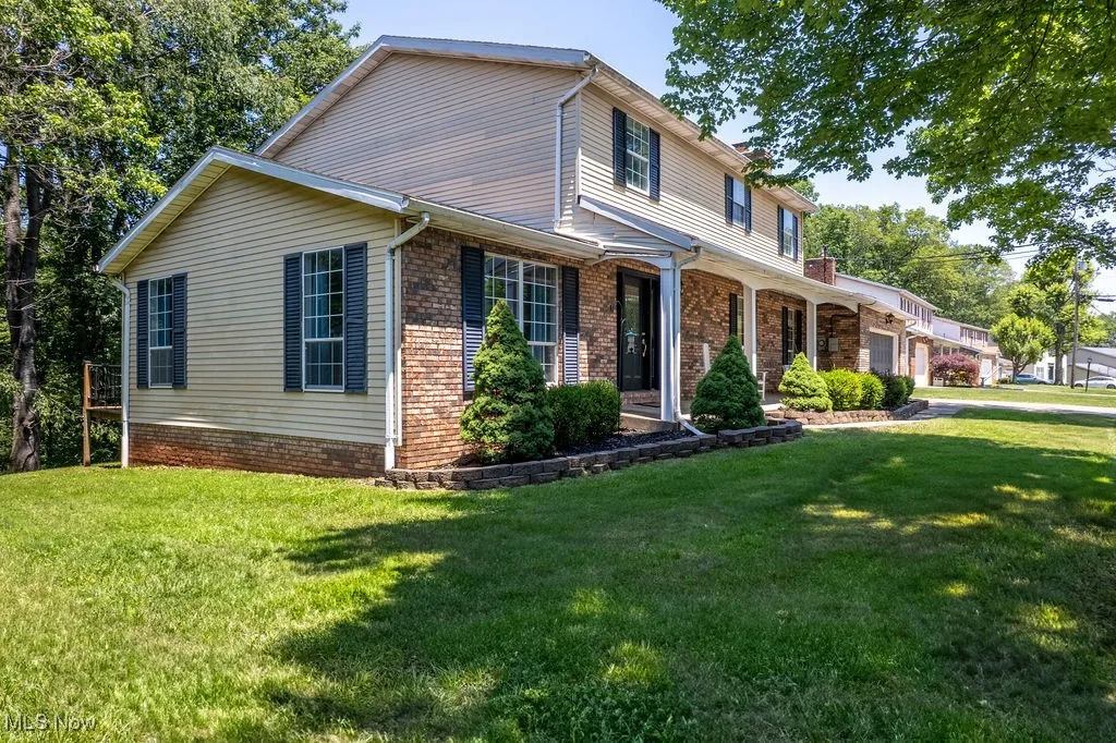 Traditional home with a garage and a front yard