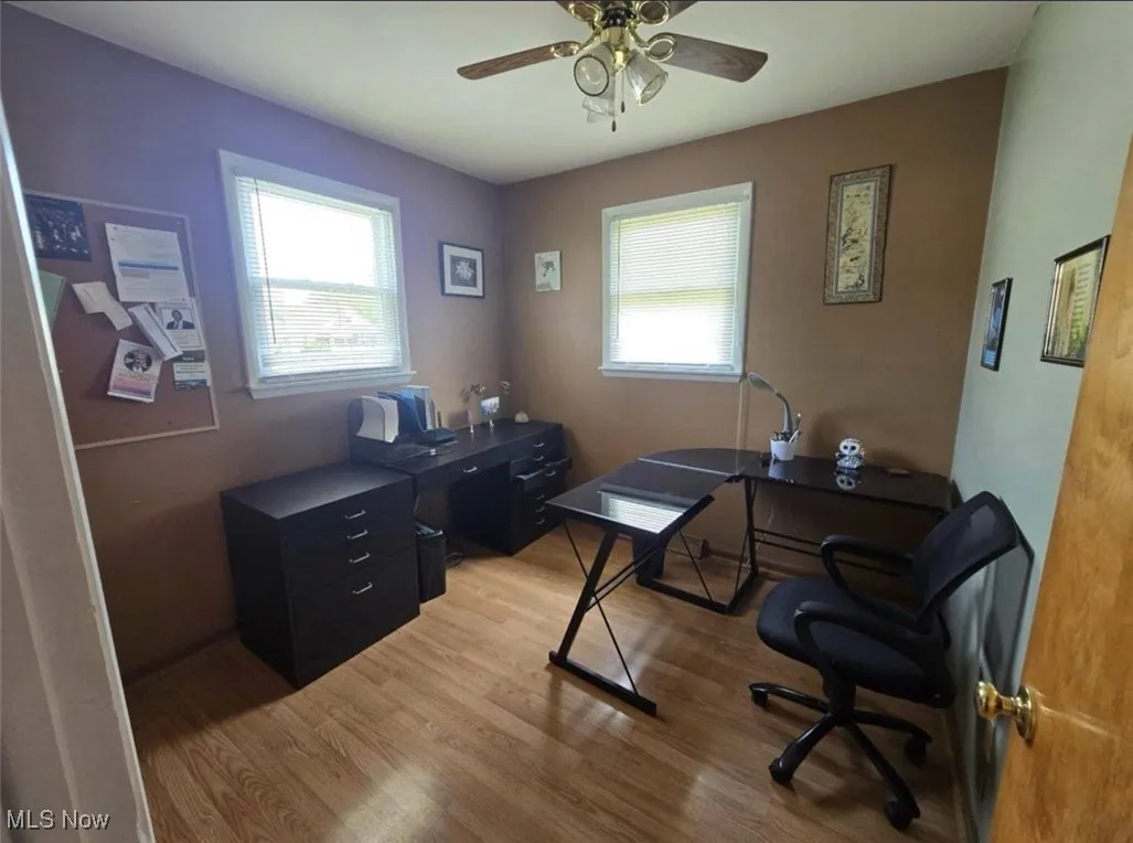 Office space featuring light wood-style floors and a ceiling fan
