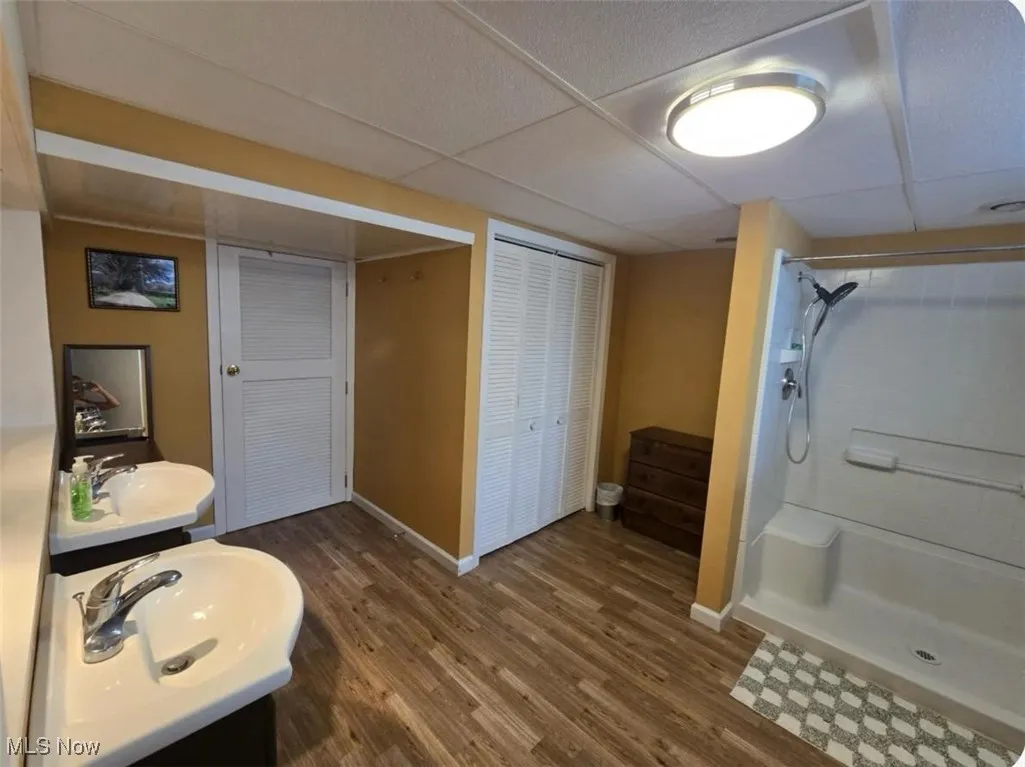 Bathroom with wood finished floors and a stall shower