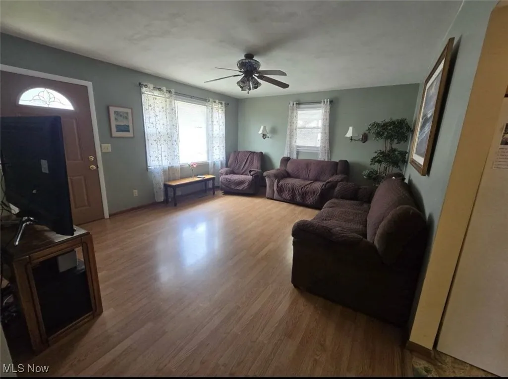 Living room with wood finished floors and ceiling fan