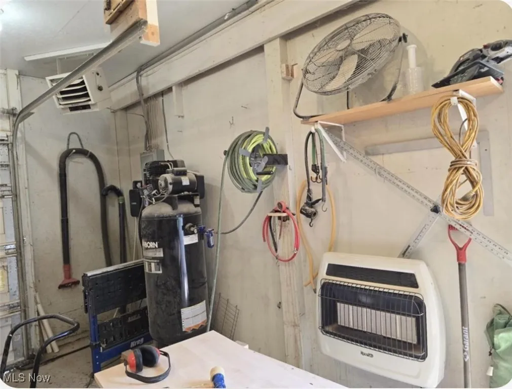 Utility room featuring heating unit