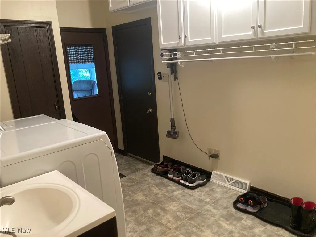 Laundry area with cabinet space and separate washer and dryer