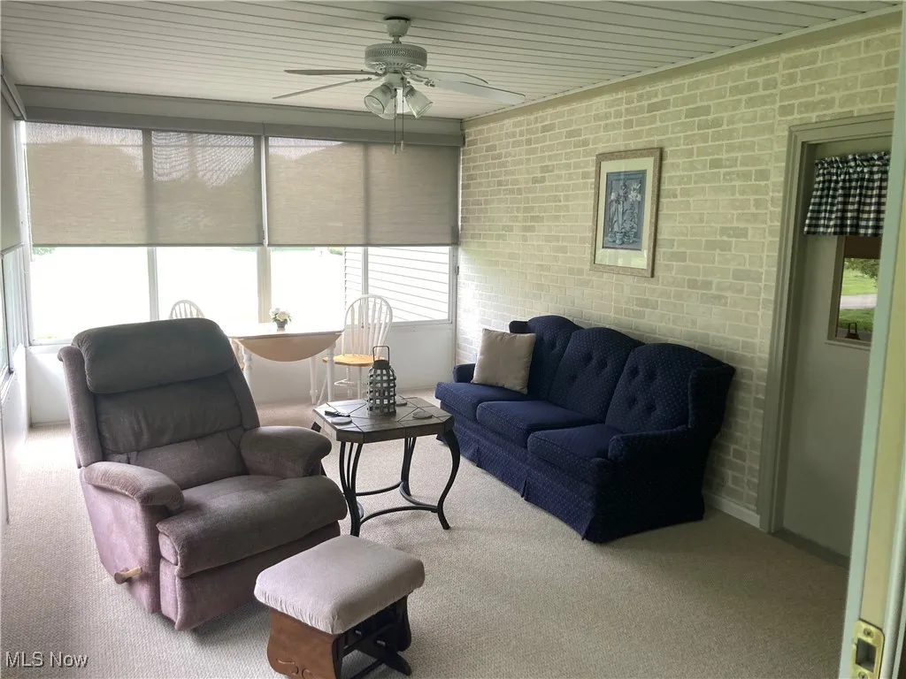 Sunroom with a ceiling fan