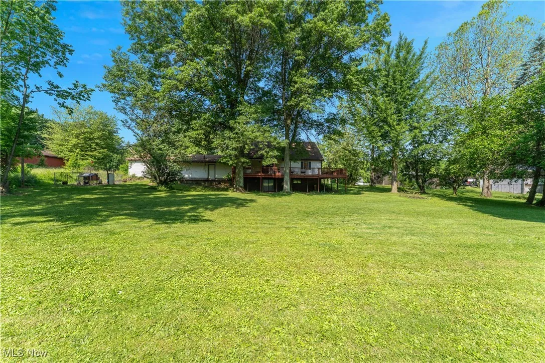 View of green lawn with a deck