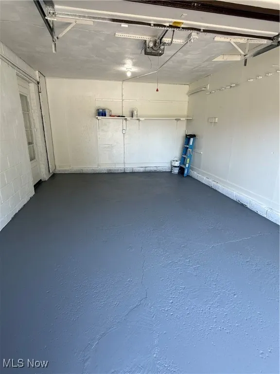 Garage featuring a garage door opener