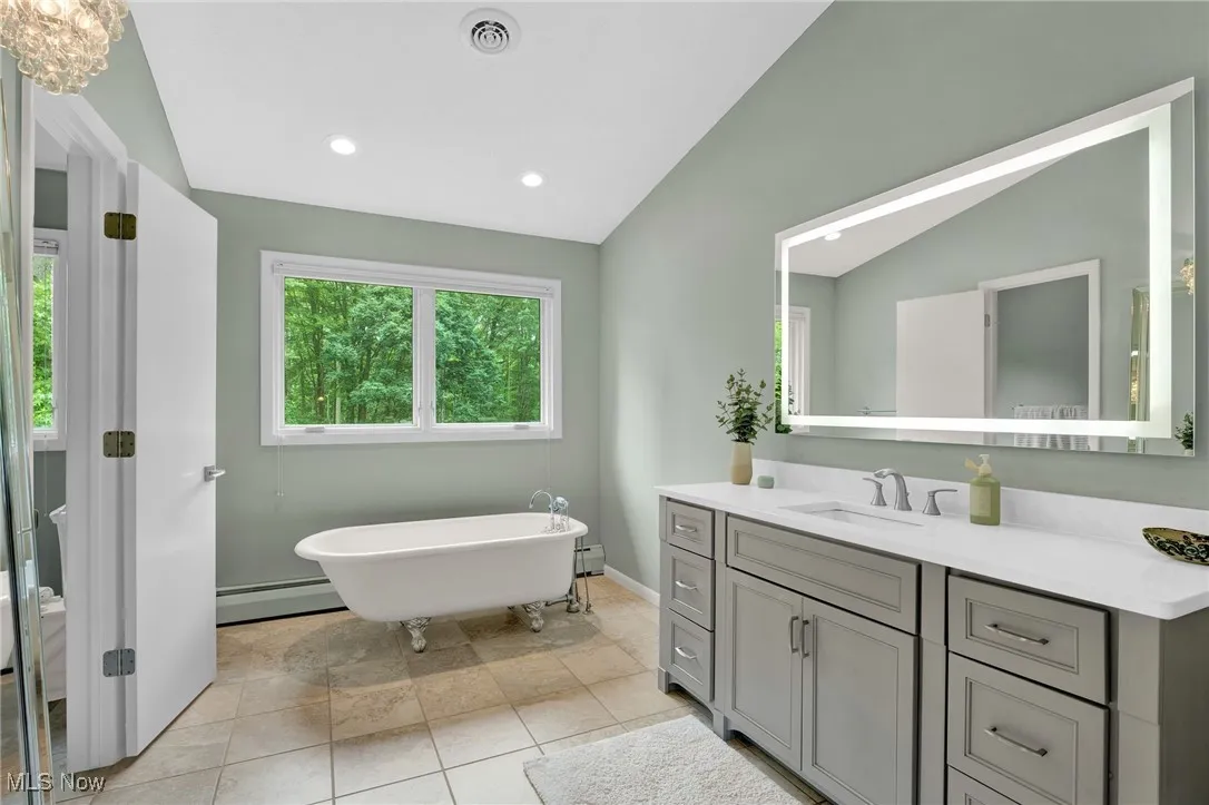 This 2nd primary bedroom ensuite bath with also make you say WOW. Renovated, lighted high-end mirror, clawfoot tub and a tiled, sitdown shower.
