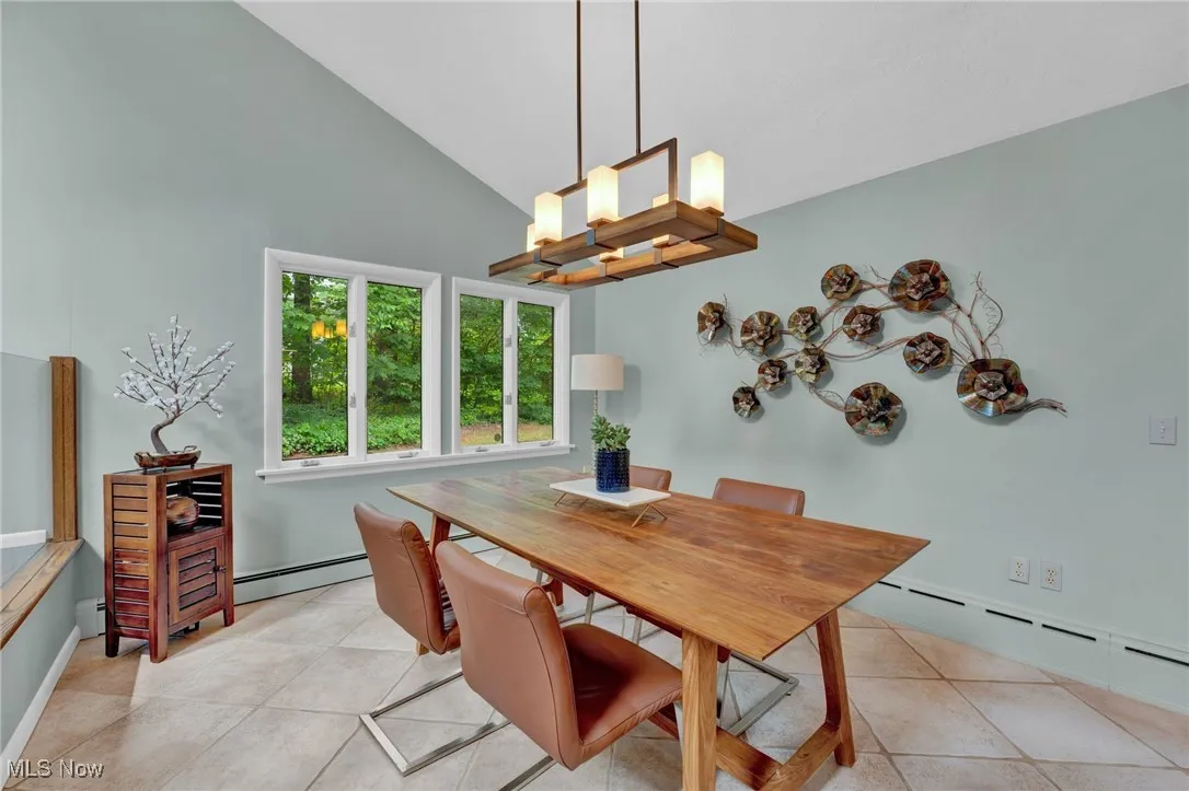 Step down to a cozy, open dining area with nearby 2 skylights, clean sightlines, unique/custom chandelier. Hosting parties with multiple dining and entertaining areas, with are both open yet distinct provides the perfect blend of casual, informal dining as well as hosting big family get-togethers.
