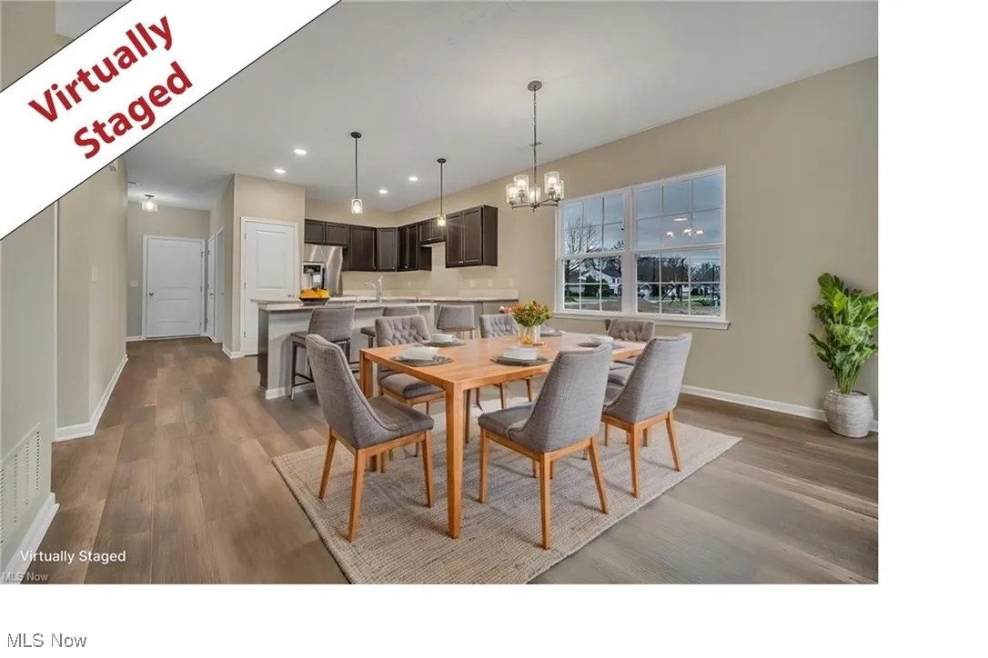 Dining space with a chandelier, wood finished floors, and recessed lighting
