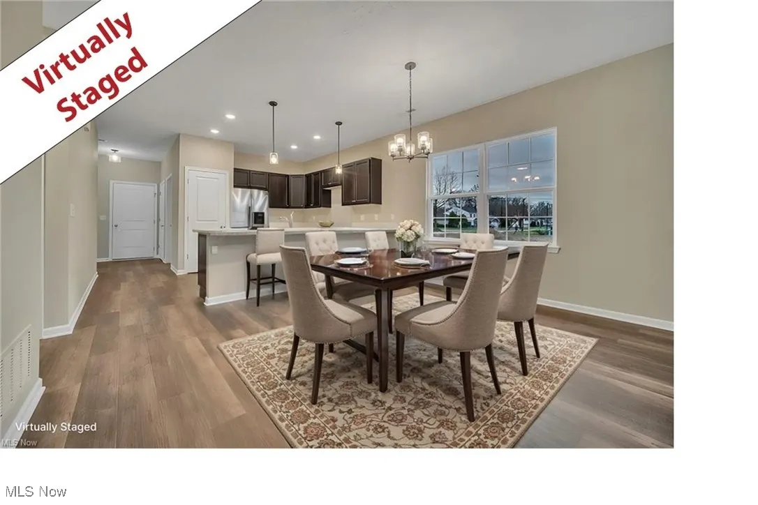 Dining space with a chandelier, dark wood-style floors, and recessed lighting