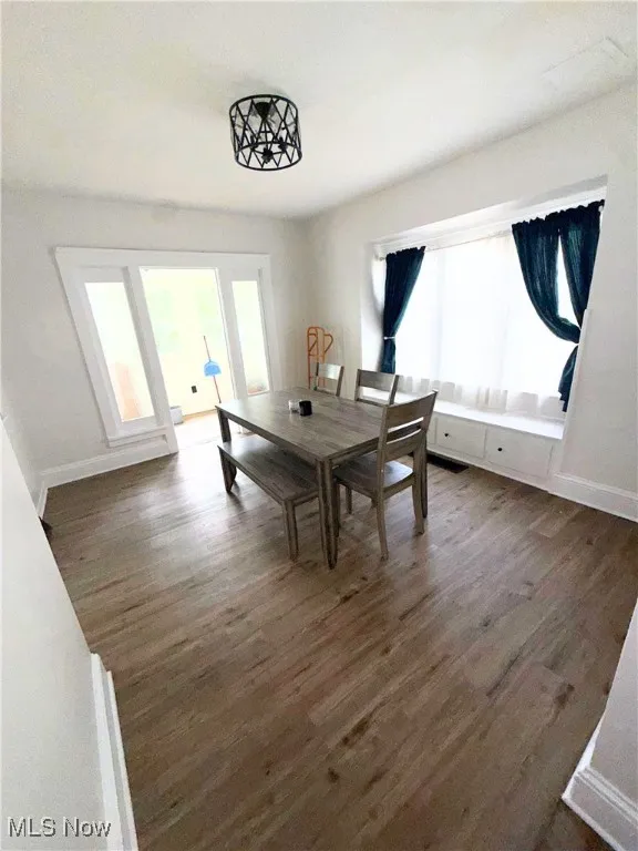 Dining area featuring wood finished floors and baseboards