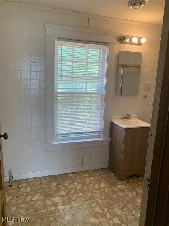 Bathroom with vanity and healthy amount of natural light