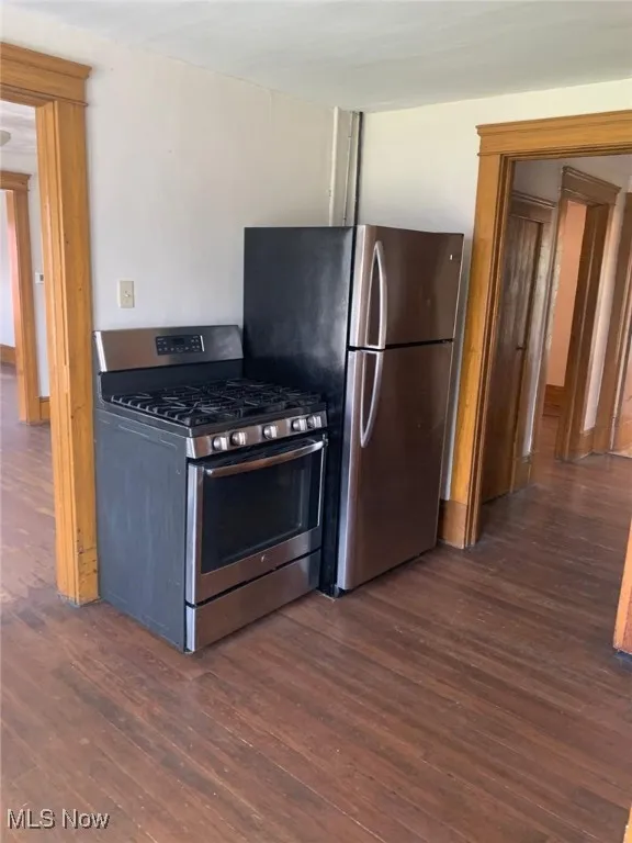 Kitchen featuring stainless steel appliances and dark wood-type flooring