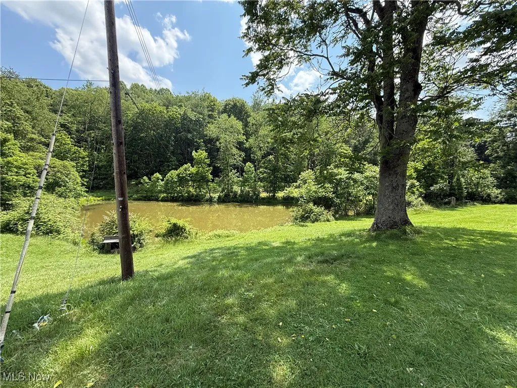 View of grassy yard with a water view