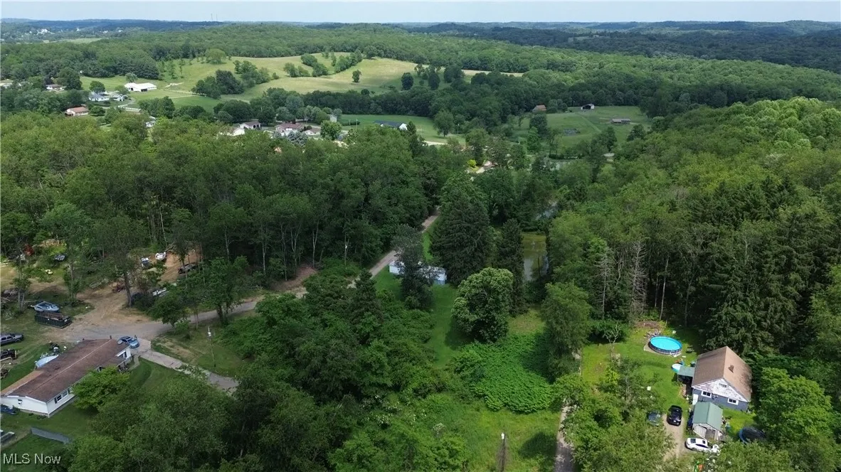 View of property location featuring a heavily wooded area