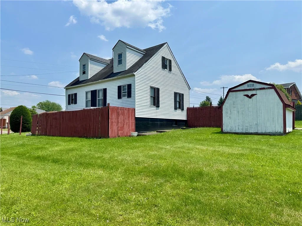 Side view of home, with shed and yard
