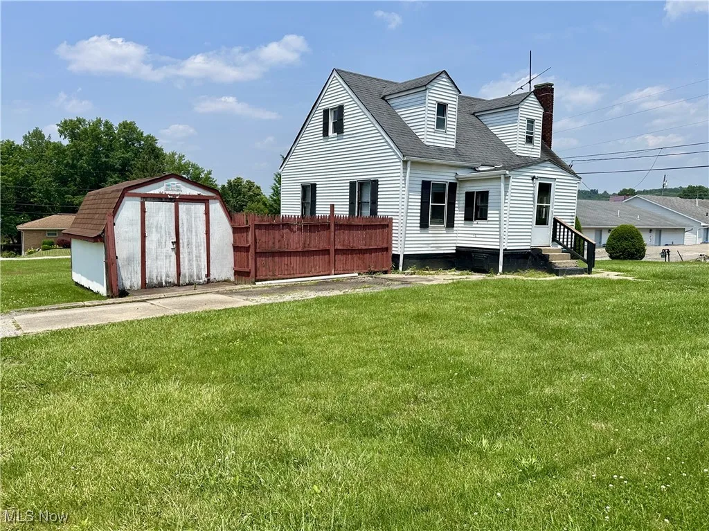 Front view of home, with shed and yard