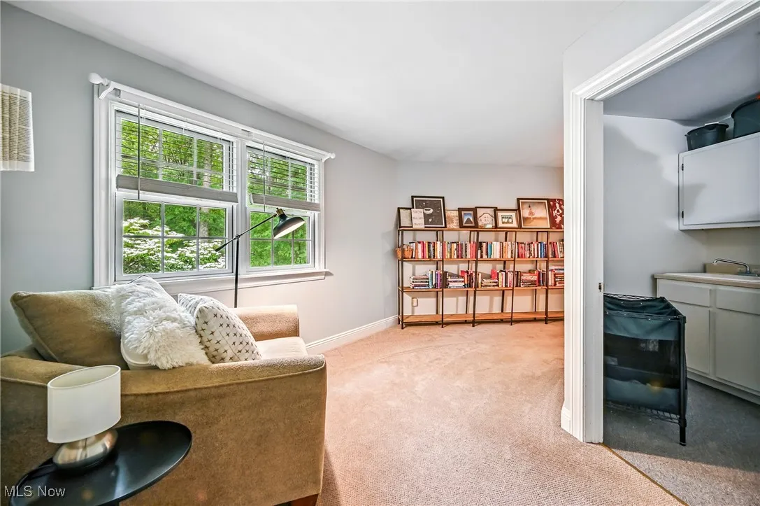 Sitting room with carpet flooring and baseboards