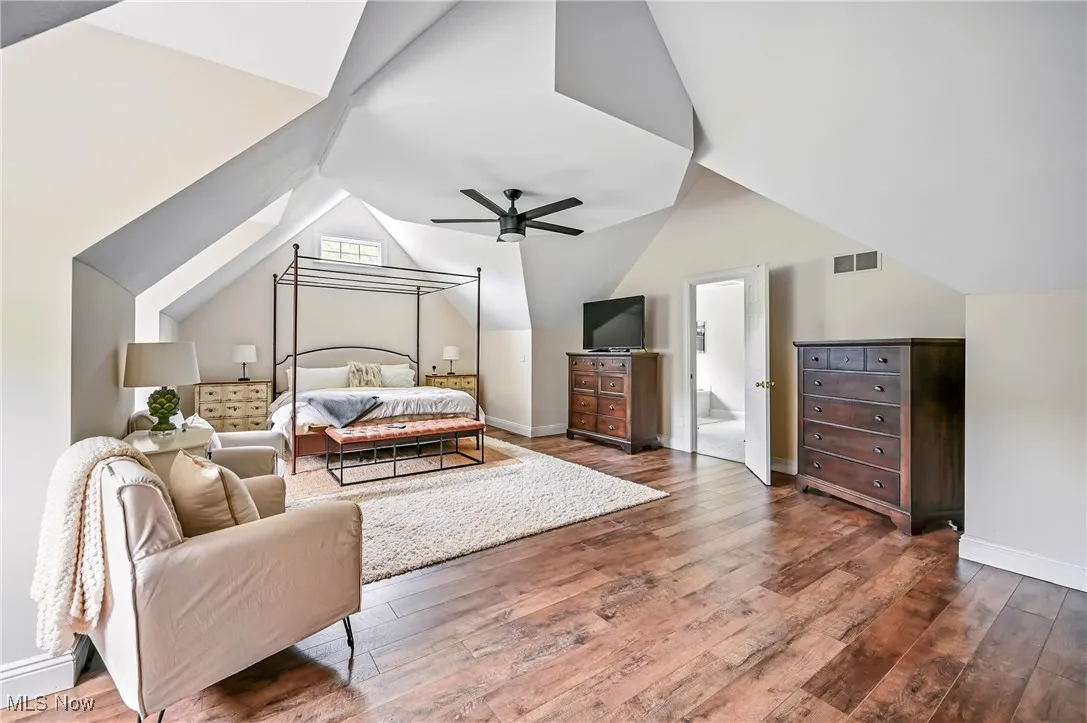 Bedroom with hardwood / wood-style flooring, lofted ceiling, and ceiling fan