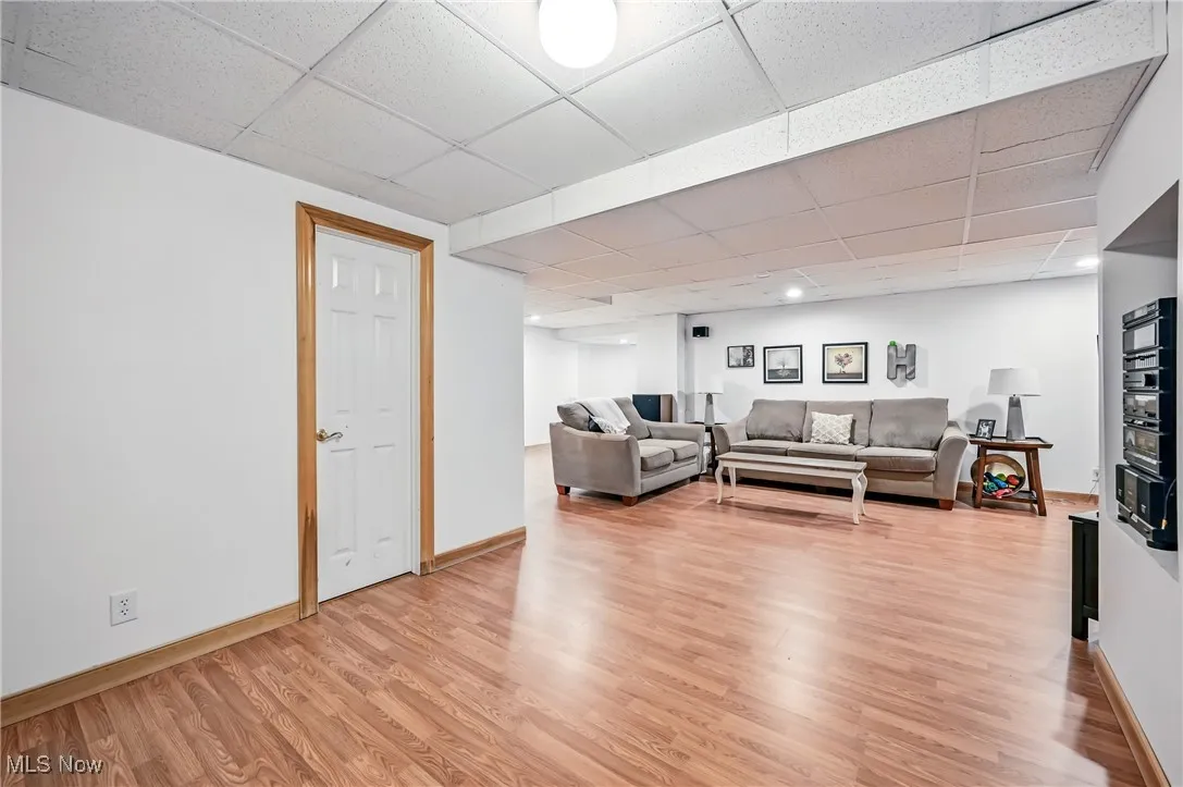 Living area featuring a paneled ceiling and light wood finished floors