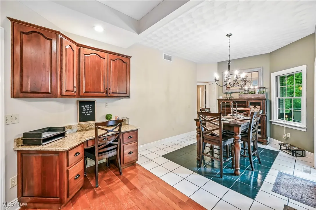Dining room featuring built in desk, a chandelier, and recessed lighting