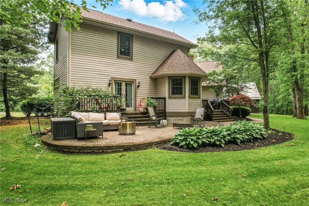 Back of property with a lawn, a patio area, outdoor lounge area, french doors, and a deck