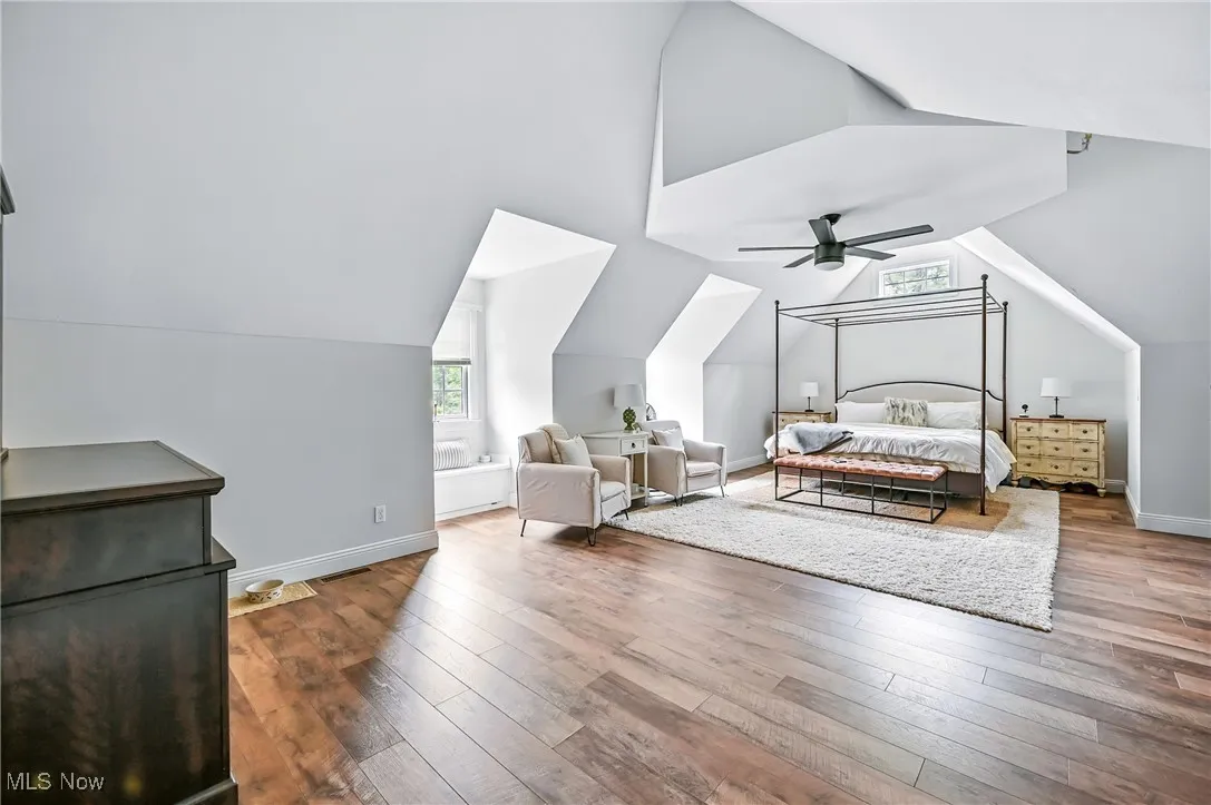 Bedroom featuring lofted ceiling, hardwood / wood-style floors, and a ceiling fan