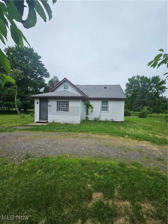 View of home's exterior with a yard