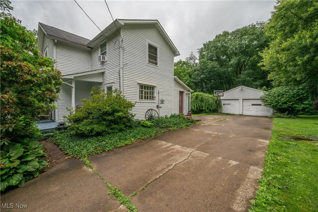View of home's exterior featuring an outbuilding and a detached garage