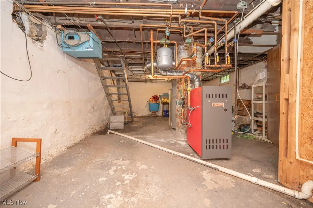 Unfinished below grade area with a heating unit