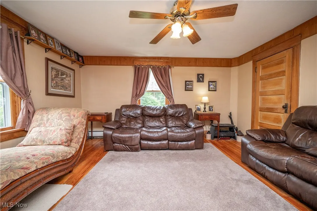 Living room with wood finished floors and ceiling fan