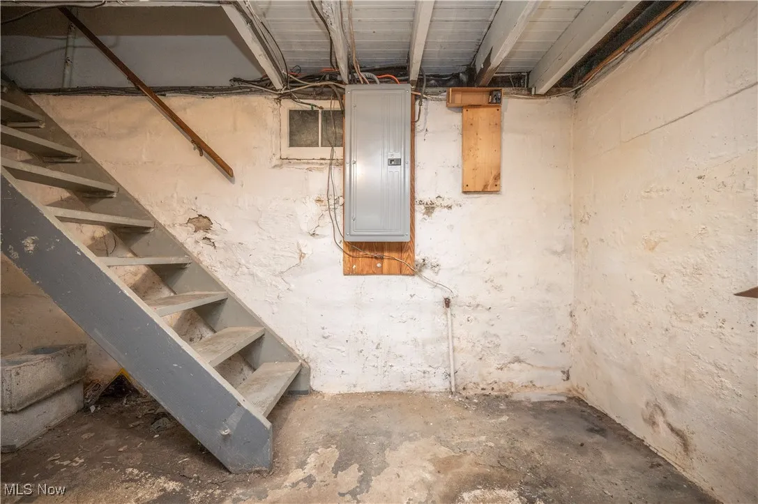 Unfinished below grade area with electric panel