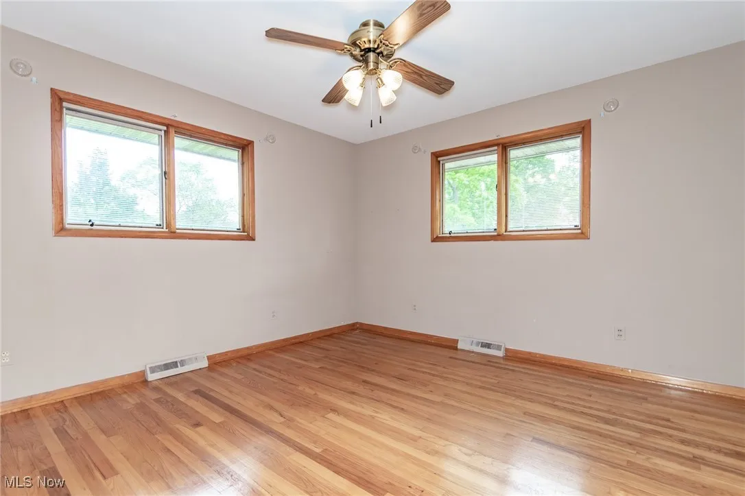 Spare room with light wood-style flooring and ceiling fan