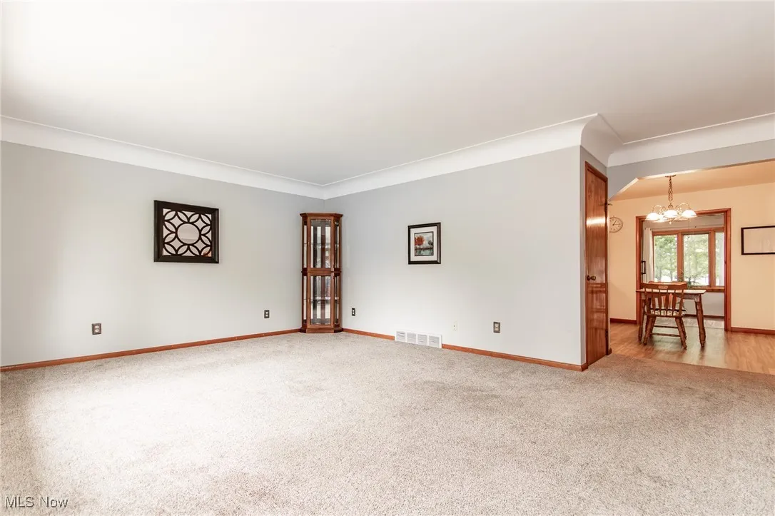Living room with carpet floors and crown molding