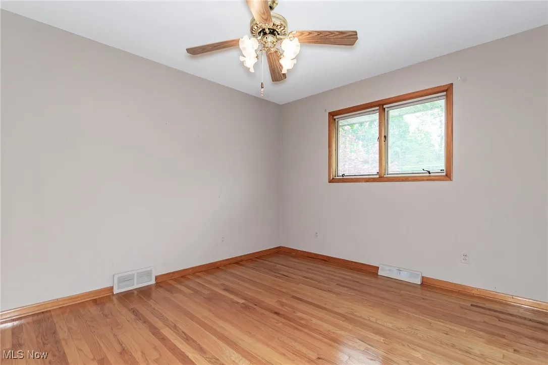 Spare room featuring light wood finished floors and a ceiling fan