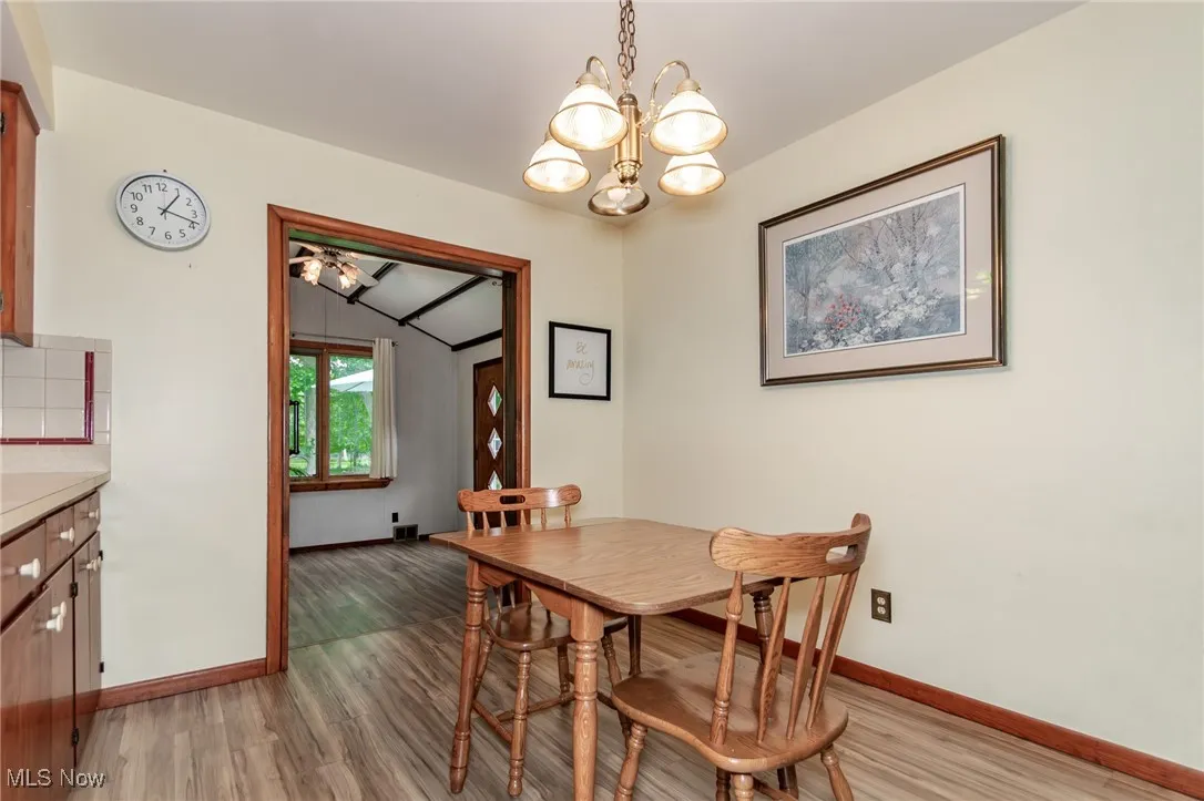 Dining area featuring light wood-style floors and a chandelier