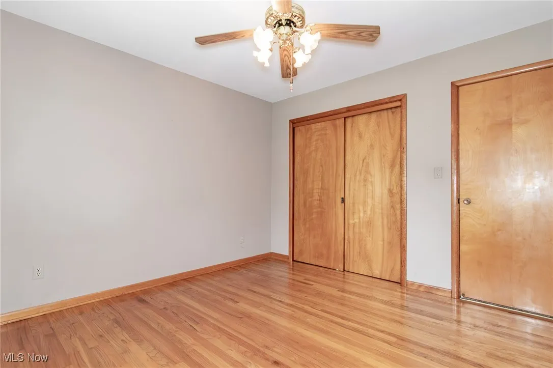 Unfurnished bedroom with light wood-style flooring and ceiling fan