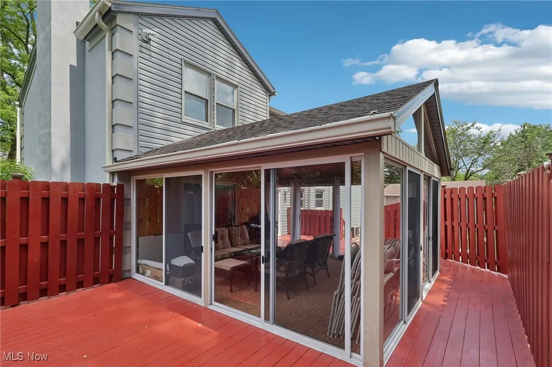 Wooden deck featuring a sunroom