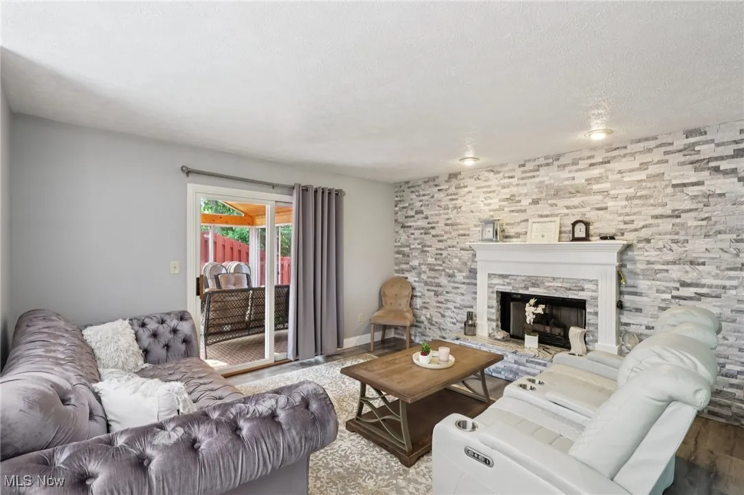Living room featuring a gas fireplace and access to three seasons room