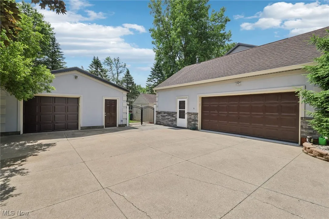 Attached 2 car garage with storage space and additional garage space.